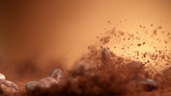 Super Slow Motion Shot of Raw Chocolate Beans Falling Into Cocoa Powder at 1000Fps.