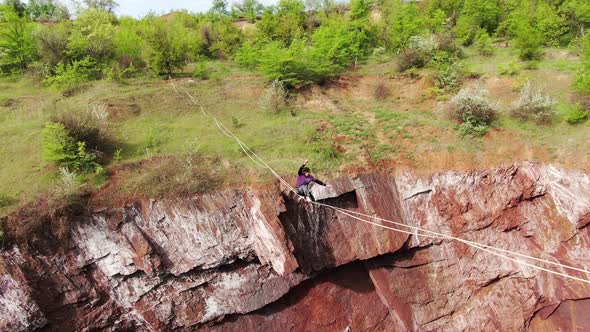 Young Man Is Slacklining Over a Huge Natural Pit Extreme Sports