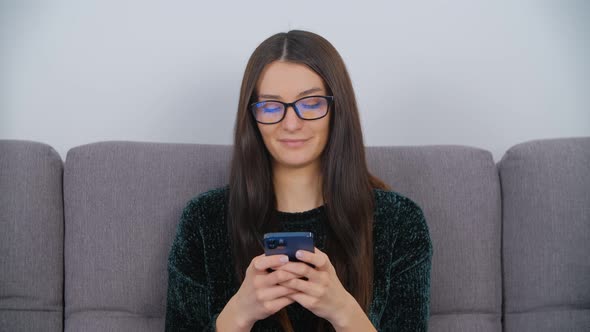 Young white woman using modern smart phone for communication on social media app in 4k video