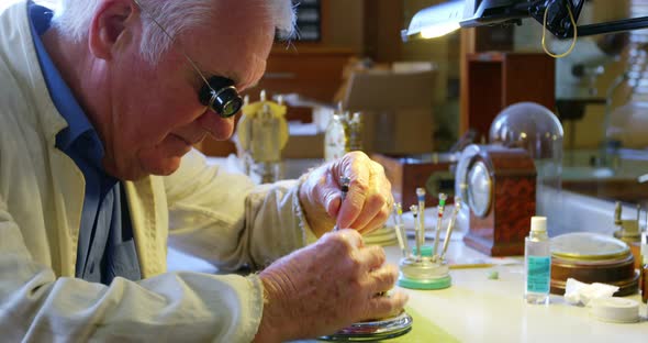 Horologist repairing a watch