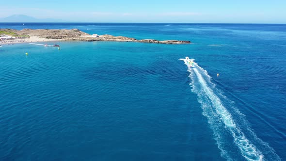 Aerial View of a Motor Boat Towing a Tube. Zakynthos, Greece