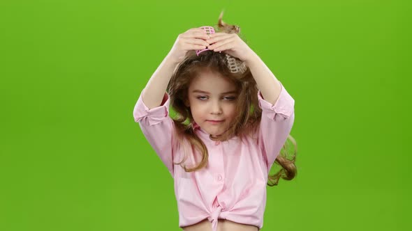 Child with Curlers on His Head, Removes Curlers. Green Screen