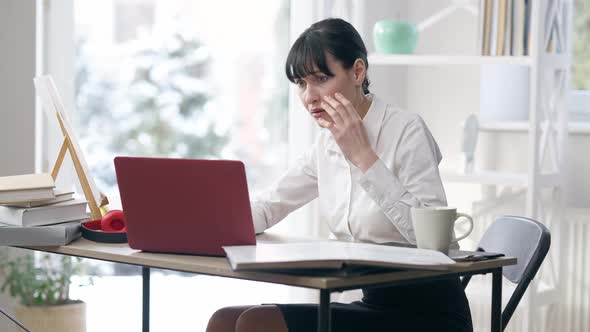 Portrait of Desperate Shocked Young Woman Looking at Laptop Screen with Dazed Facial Expression