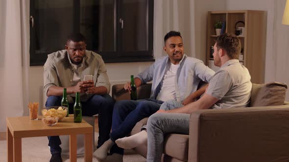 Male Friends Drinking Beer and Talking at Home