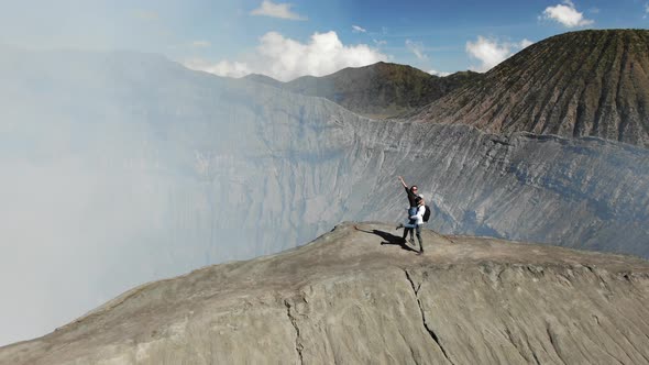 Couple hugging on ridge of Mount Bromo volcano