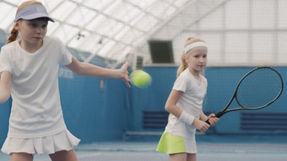 Young Girls Practicing Tennis On Court