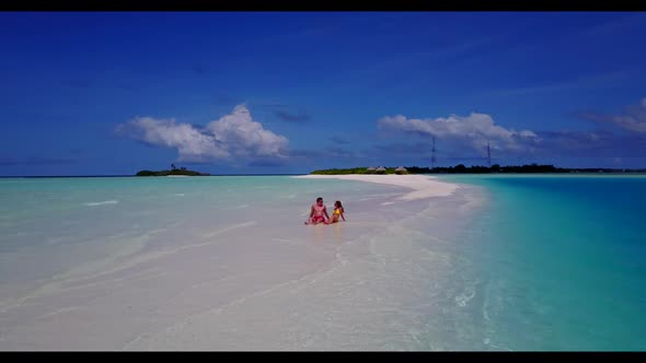 Guy and girl tan on beautiful island beach time by transparent water with white sandy background of 