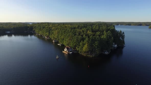aerial beautiful cottages on lake muskoka reverse flight scenery 4k