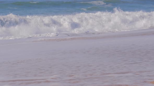 Sandy Beach and Waves of Ocean