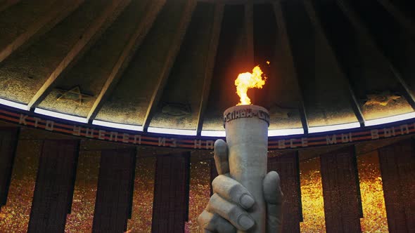 A sculpture of a hand with an eternal flame in the pantheon of glory