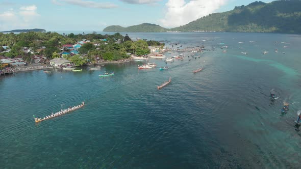 Aerial: kora-kora traditional canoe annual race in Bandaneira and speed boats