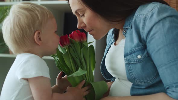 Handheld video of toddler giving flowers to his mother. Shot with RED helium camera in 8K 