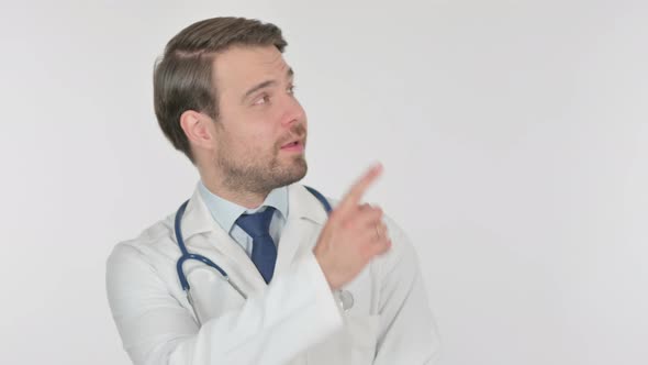 Young Doctor Pointing on Side on White Background