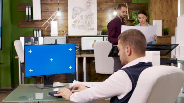 Creative Architect Working on Computer with Blue Screen