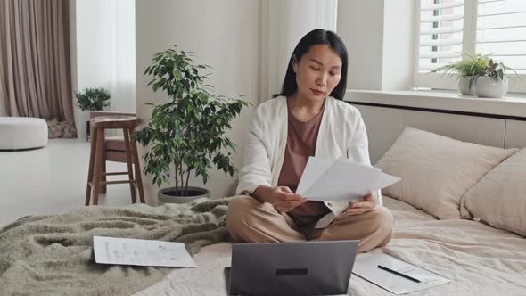 Asian Freelancer Posing on Bed