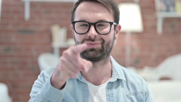 Portrait of Cheerful Beard Young Man Pointing Finger at the Camera