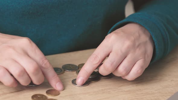 Female Woman Hands Calculating Counting Money Coins Euro Cents on Wooden Table