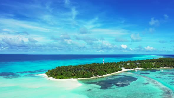 Beautiful drone tourism shot of a sandy white paradise beach and blue ocean background in hi res 4K