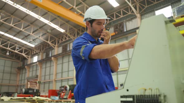 Caucasian handsome male industrial worker work in manufacturing plant.