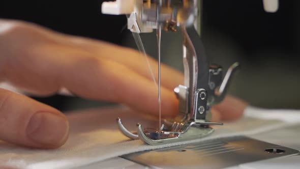 Woman Using Sewing Machine at Home