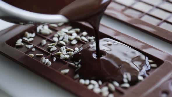 Woman Make Homemade Chocolate Candy Bar with Nuts