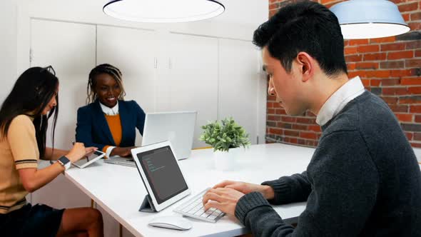 Male executive using digital tablet at desk