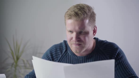 Close-up of Angry Caucasian Man Looking Through Documents and Throwing Papers Away, Furious