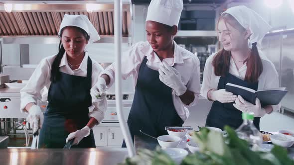 Group of schoolgirls having fun learning to cook. Female students in a cooking class.