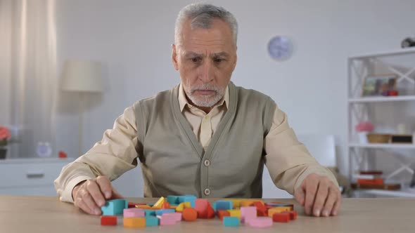 Confused Pensioner Trying Remember to Combine Blocks, Brain Disease, Alzheimer