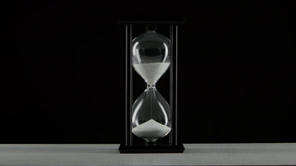 Black Hourglass. White Sand. Black