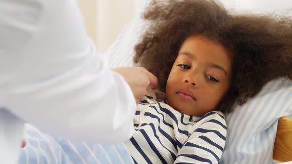 Doctor Measuring Sick Girl's Temperature