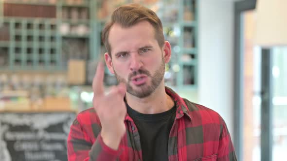 Portrait of Annoyed Young Man Arguing Fight