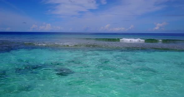 Daytime overhead abstract view of a white sandy paradise beach and blue ocean background in colorful