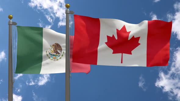 Mexico Flag Vs Canada Flag On Flagpole