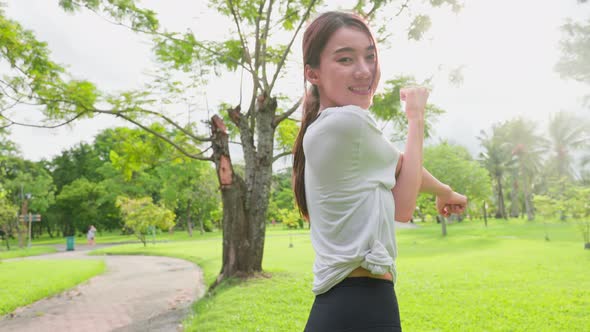 Portrait of Asian active sport woman stand with confidence after exercise outdoors at public park.