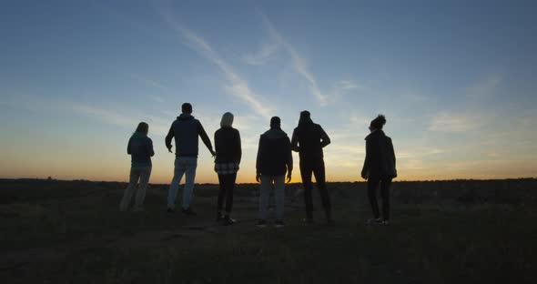 Friends Walking Together Into the Setting Sun