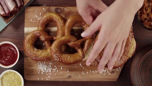 Breaking Off Fresh Baked Pretzel Top View