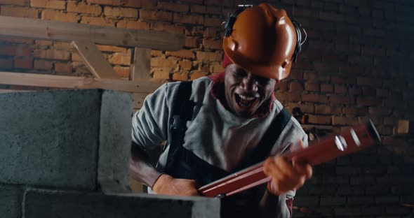 Cheerful Black Man Singing Song on Construction Site