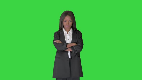 Confident African American Businesswoman with Crossed Arms on a Green Screen, Chroma Key.