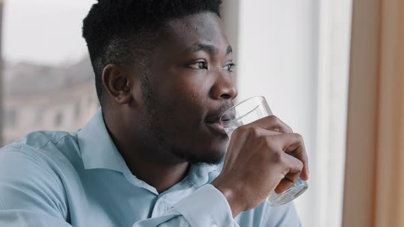 African American Young Dreaming Man Thoughtful Positive Guy Turn Head Look at Window Drink Fresh