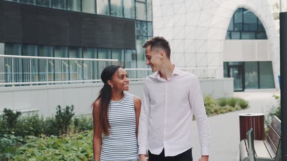 Mixedrace Family Spending Time Together Outdoors in a City with Modern Architecture