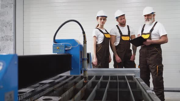 Three Engineers Inspecting Plasma Cutter