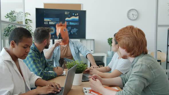 Guy Wearing Horse Mask Leading Business Meeting Talking to Employees Then Leaving Office