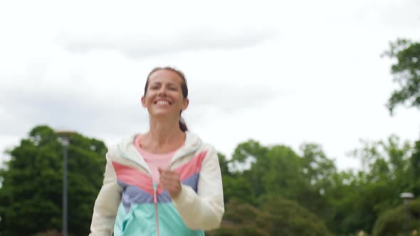 Smiling Woman Running Along Park 46