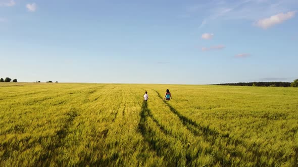 Mother with Her Son Walking on the Field