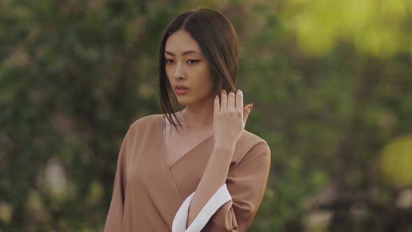 Asian Woman in Traditional Japanese Kimono Outdoors