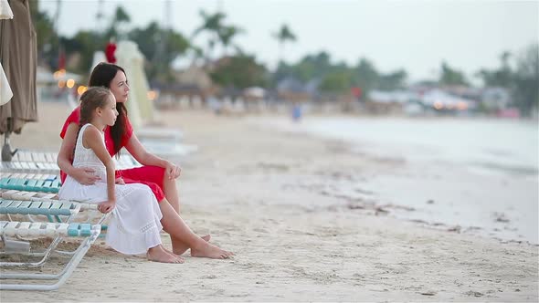 Family of Mom and Kid Enjoy the Sea View on White Beach. Family Relaxing Sitting on the Sunbed