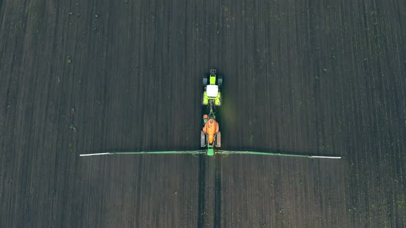 Aerial View on Top. Farm Machinery Spraying Insecticide To the Green Field, Agricultural Natural