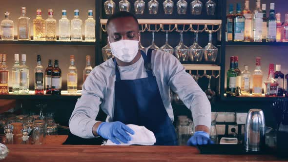 Male African Barista is Wiping the Counter