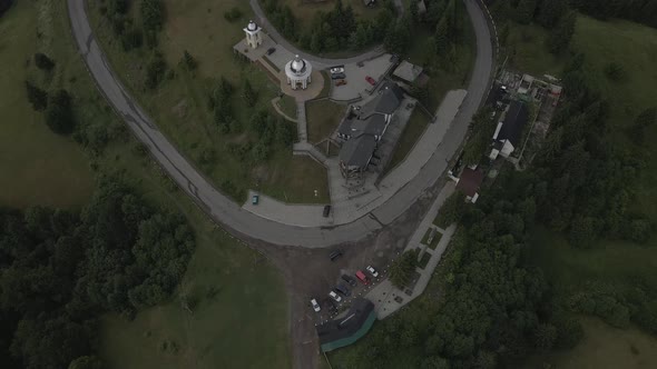 Top View of a Car Driving on a Road Near the Hotels in the Mountainside